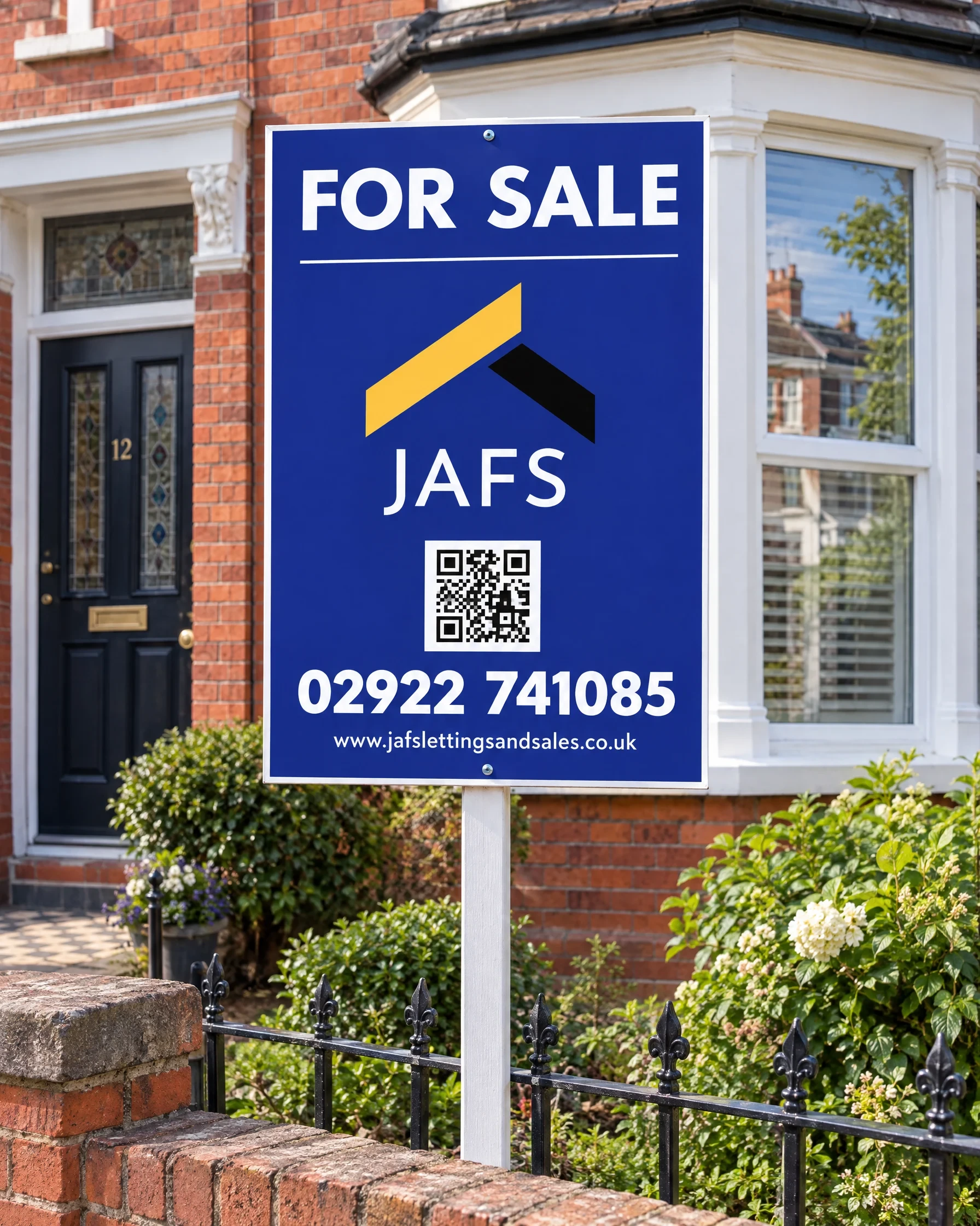A blue and amber JAFS For Sale board outside a red-brick Victorian house